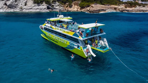 Glass bottom boat sailing near limestone sea caves on Mallorca’s east coast