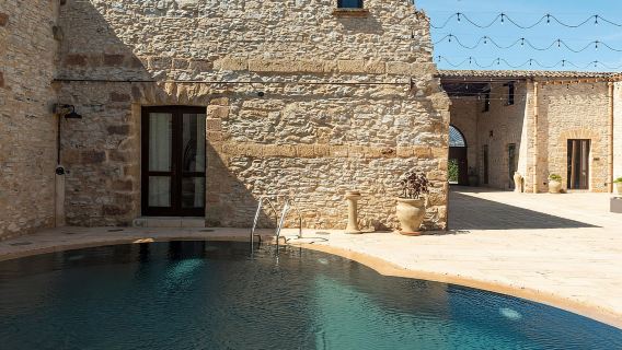 Nature and relaxation by the pool at Baglio Passofondo Estates