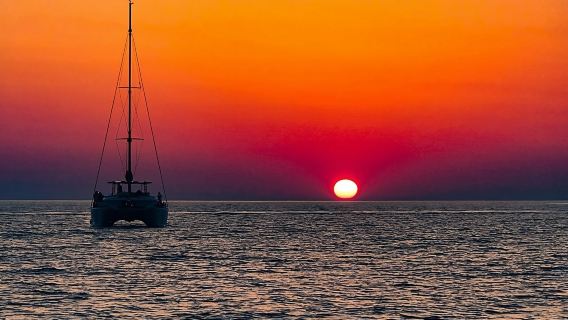 Sunset cruise around Santorini, Greece on a luxury Sailing|Includes BBQ dinner + drinks+ transfer