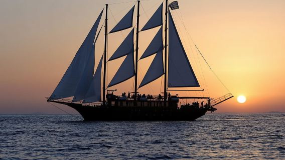 Santorini Volcanic Island and Sunset Dinner one-day tour in Greece|Wooden Sailing out to sea|Island-wide transfers