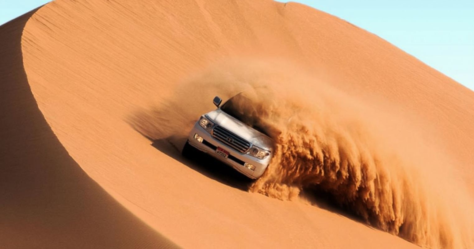 Dubai Desert Quad Bike Adventure Tour with Dune Bashing, Sandboarding and Camel Riding
