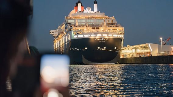 Hamburg evening lights cruise with a large ship