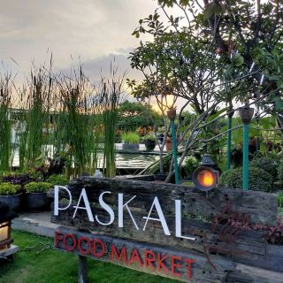 Paskal Food Market. This food court has an open space kind of design with great ambiance. But they also provide space with roof. They have quite large size of space. They have many food stall with also many different type of food choices from snacks to main course. The price of the food is friendly. They provide halal and non-halal food. We can pay the bill with cash or non cash with no minimum order. Near the entrance, at the upfront of this food court, there's a stage surrounded by a fish pound with a fountain on one side. Usually they held a band performance on the weekend. The children can play on the stage when there's no performance. They designed the space with plants and small trees. The lamp at the open space designed like candles arrangement. They don't split the smoking & no smoking area. I often visit this food court because i love the ambiance & a lot of food choices.
#wintergetaway 
#happynewyear 
#tripinspired 
#wintergetaway#tripinspired#happynewyear
