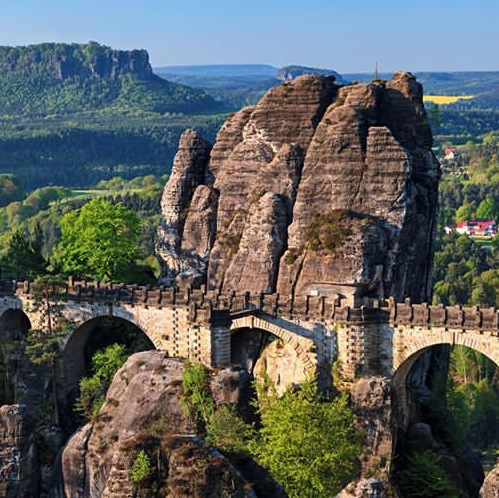 #tripaway Over millions of years, Elbe River has carved the graceful rock landscape and romantic gorges and valleys of Saxon-Bohemian Switzerland. The total area of a wilderness of Elbe Sandstone Mountains is more than 700 km2. It is divided between two countries: Germany and Czechia. There is a Saxonian Switzerland National Park with an area more than 93 km2 in Germany and Bohemian Switzerland National park in Czechia with a 79 km2 area. So there is plenty of space to explore besides Bastei. The name of Saxon Switzerland was given to the place by two Swiss painters Adrian Zingg and Anton Graff, who worked at the Academy in Dresden and painted the landscape along the Elbe in the 18th century.11 bastei saxony germany thesanetravel.com 1390462

How to get there from Dresden?
Regional trains ("S-Bahn") connect Dresden and Saxon Switzerland at least every 30 minutes during the day. They stop in Pirna, Obervogelgesang, Stadt Wehlen, Kurort Rathen, Königstein and Bad Schandau. To me, the easiest way to get to Bastei from Dresden is by S-Bahn getting out at Kurort Rathen station, then taking a short ferry boat ride across the Elbe and hiking up to Bastei and Bastei Bridge. Bastei & Bastei Bridge, the highlights of Saxon Switzerland in Germany are free of charge! There are no opening or closing times. The area is not fenced. You can visit the famous Bastei rock formations at any time of the year.
#tripaway