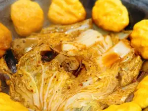 Stewed river fish in an iron pan