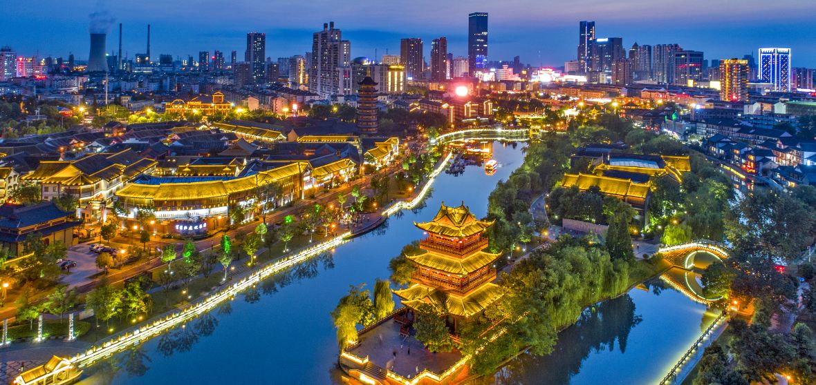 Night view of Huai'an's Grand Canal with ancient architecture and modern skyline