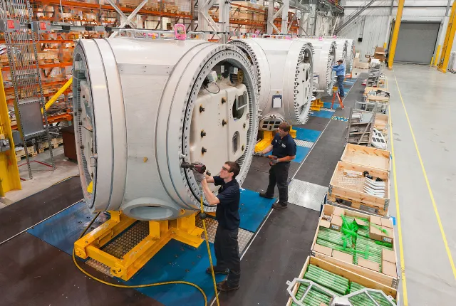 Workers assembling wind turbines