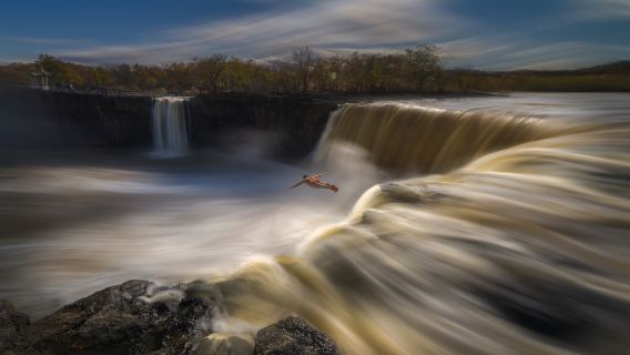 Cliff Waterfall Diving Performance at Jingpo Lake Scenic Area