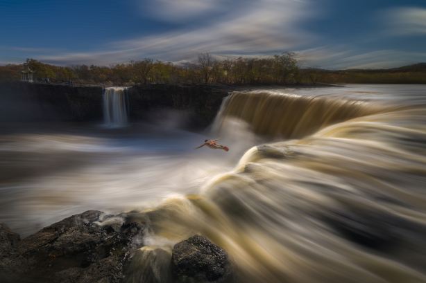 Cliff Waterfall Diving Performance at Jingpo Lake Scenic Area