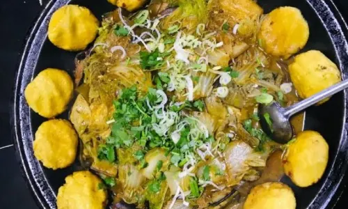 Stewed river fish in an iron pan