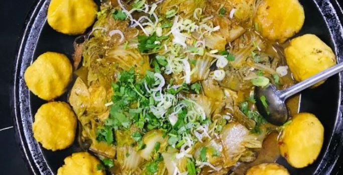 Stewed river fish in an iron pan