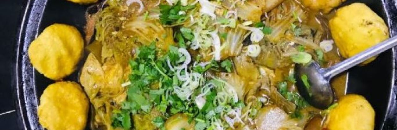 Stewed river fish in an iron pan