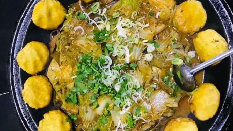 Stewed river fish in an iron pan