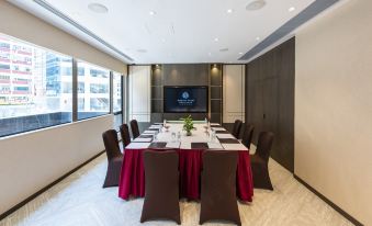 There is a spacious conference room equipped with a long table and chairs suitable for meetings and other business events at Empire Hotel Hong Kong－Wan Chai