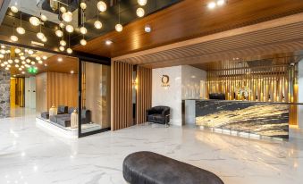 In front of the entrance to an office, there is a lobby with two chairs and tables at Orion Hotel & Residence Bangna