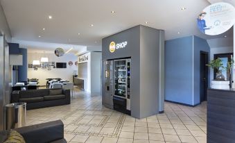 "a vending machine in a lobby , with the word "" shop "" prominently displayed on the front" at B&B Hotel Bologna