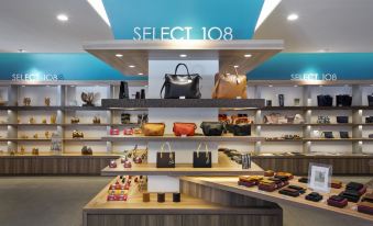 a store display with various handbags on display , including a black leather tote and brown leather handbags at The Lake View Toya Nonokaze Resort