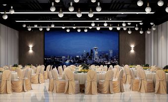 A room is set up with tables and chairs in front of large windows for an event at Shenzhen Hyde Hotel