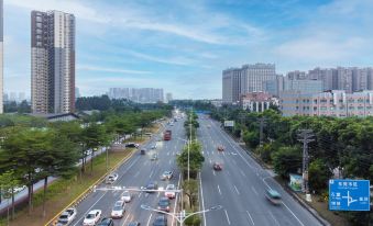 There is an elevated city street with cars and buildings on both sides at OSK International Hotel