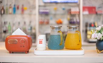 There is a tray with cups and bottles on it placed on the counter in front at Ibis Hotel (Shanghai New International Expo Center Lianyang Branch)