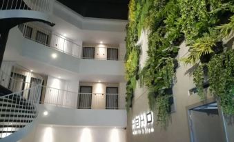 "a building with multiple balconies and a sign that says "" hotel "" on the side , surrounded by greenery" at Hako Hotel (Mount Austin)