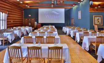 a large dining room with multiple tables and chairs , each set for a meal , is shown in the image at The Waters of Minocqua