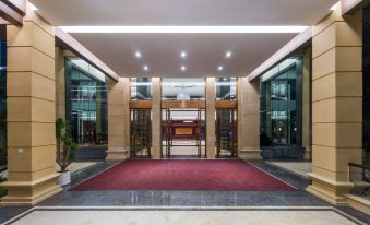 The entrance to a building is characterized by large windows and doors on both sides, providing access to another area at Fuzhou Oriental Yanzhuo Hotel