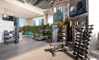 The gym, which has multiple treadmills and chairs positioned in front of its large windows, is currently open at iclub Mong Kok Hotel