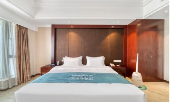 In the middle room, there is a large bed with wood paneling and white drapes on both sides at Huachen San Siro Hotel