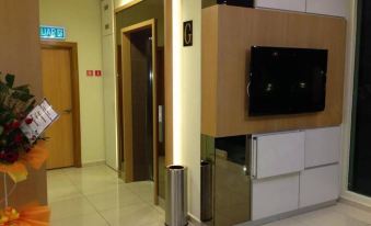 a modern office building with an elevator and a flat screen tv mounted on the wall at Caspari Hotel