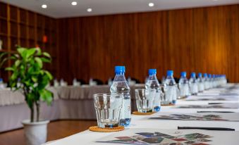 a long table with water bottles and glasses in a conference room set up for a meeting at Alba Wellness Valley by Fusion