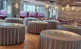 A room is prepared with tables and chairs for an event at a hotel or conference venue at Country Inn & Suites by Radisson, Guangzhou Yonghe Branch