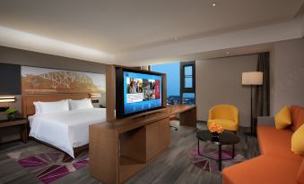 The room is furnished in an ultra-modern style and features large windows, a bed, and a desk at Hampton by Hilton Beijing Guomao CBD