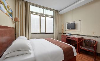 A bedroom is furnished with a double bed, desk, and large window in the middle at Hanqun Hotel (Guangzhou Baiyun International Airport)