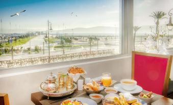 a dining table set with a variety of food and drinks , including plates , cups , and utensils at Marina Bay City Center
