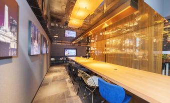 There is a long table and chairs in an office with wood paneling on the walls behind it at CitiGO Hotel, West Nanjing Road, Jing'an Temple, Shanghai