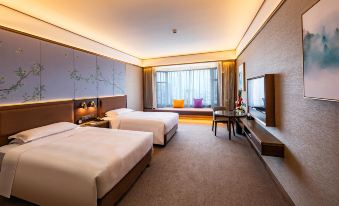 a modern hotel room with two beds , a window , and a couch , all decorated in neutral colors at Millennium Harbourview Hotel Xiamen