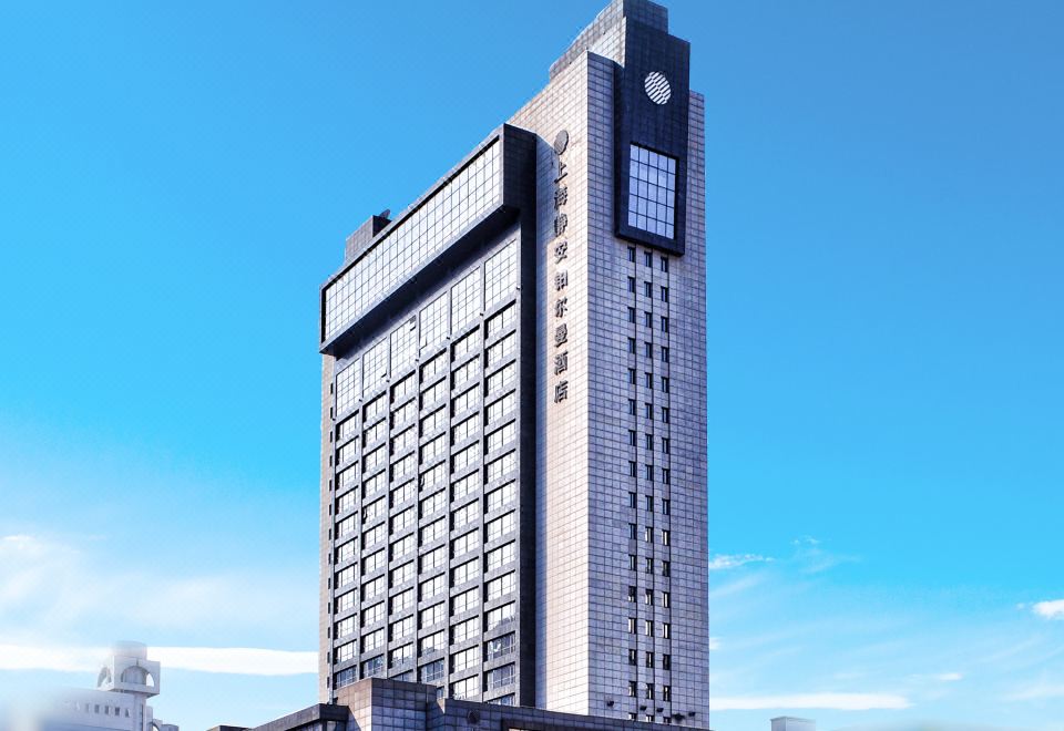 A large building with a clear view of the blue sky in front at Pullman Shanghai Jing An