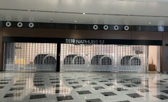 There is a spacious, vacant room with a direct entrance to the terminal and a sign on the wall indicating no entry at Ke Sleeping Lounge (Beijing Daxing Airport Terminal)