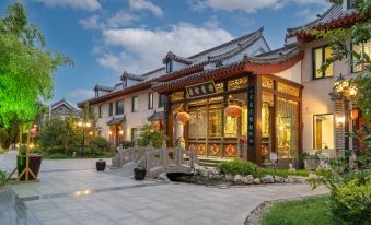 In Japan, there is a large building with multiple small shops and an entrance to the main street at Fuzi Binshe Family Education Culture Boutique Hotel