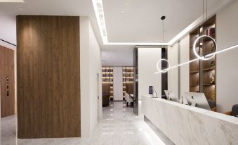 a modern office lobby with a marble reception desk and a large wooden wall mural at Suisse Apartment Hotel Suzhou Jinji Lake Expo Center