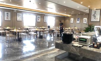 Guests have the option to dine in a centrally located restaurant with tables and chairs, as well as in other adjacent rooms at OSK International Hotel