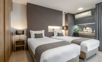 a modern hotel room with two beds , white bedding , and wooden headboards , along with two lamps on either side of the beds at NAP in Fest