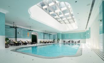 The indoor swimming pool has a spacious ceiling and a deep water level at Lisboeta Macau