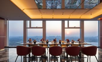The restaurant offers a scenic view of the city through its large windows and can accommodate up to 10 people at its tables at Radisson RED Guang Zhou South Railway Station