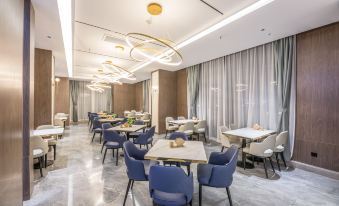 a modern dining room with several tables and chairs arranged for a group of people at Suisse Apartment Hotel Suzhou Jinji Lake Expo Center