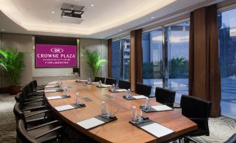 A spacious conference room with a long table and chairs is available for meetings or boardroom purposes at Crowne Plaza Guangzhou City Centre