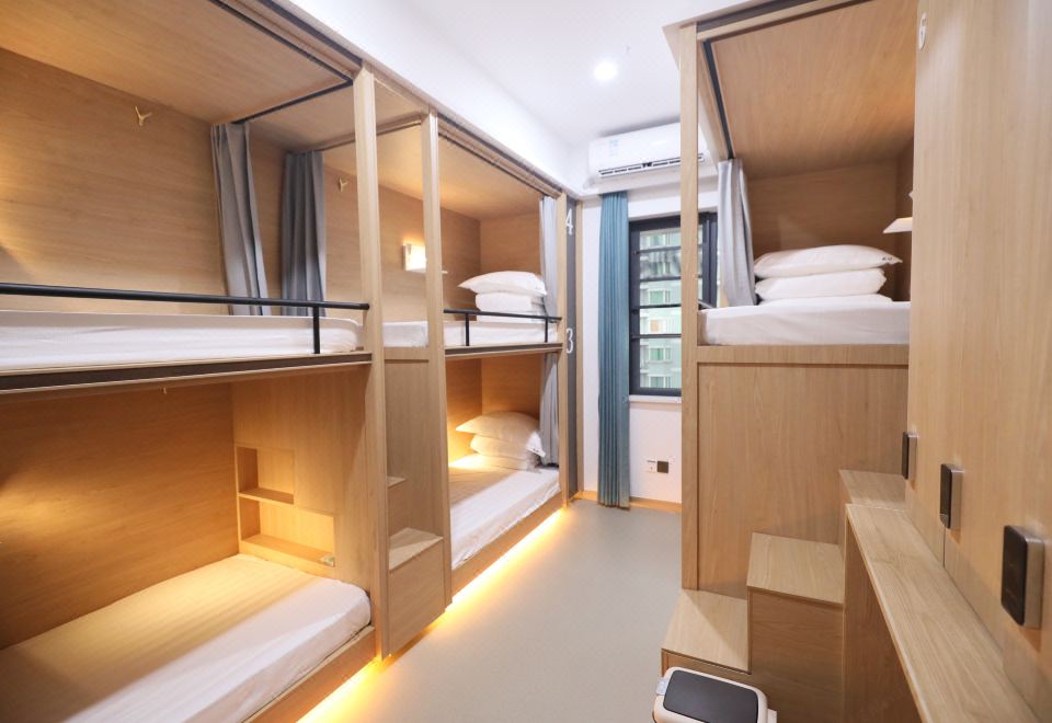 The bedroom features bunk beds and an open doorway connecting to another area at Hangzhou Wulin International City Camp (West Lake Wulin Gate Subway Station Store)