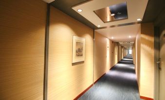 In the main room of this modern home, there is a long hallway with doors and tiled floors at Prudential Hotel