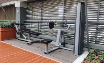 The gym, which has an outside view, also serves as storage with a bench in front at Lavande Hotel (Kunming Xishan Wanda Plaza Railway Station)